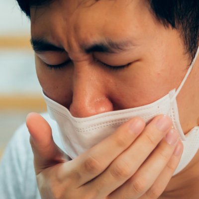 Man with mask coughing